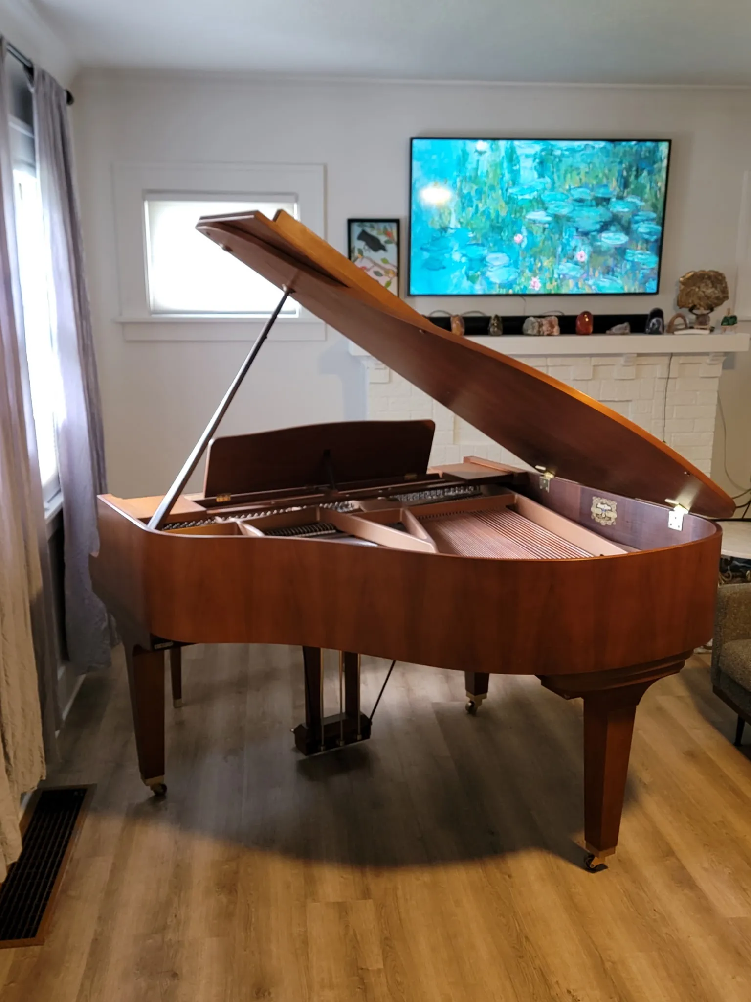 A grand piano set up in a bright living room after a careful move