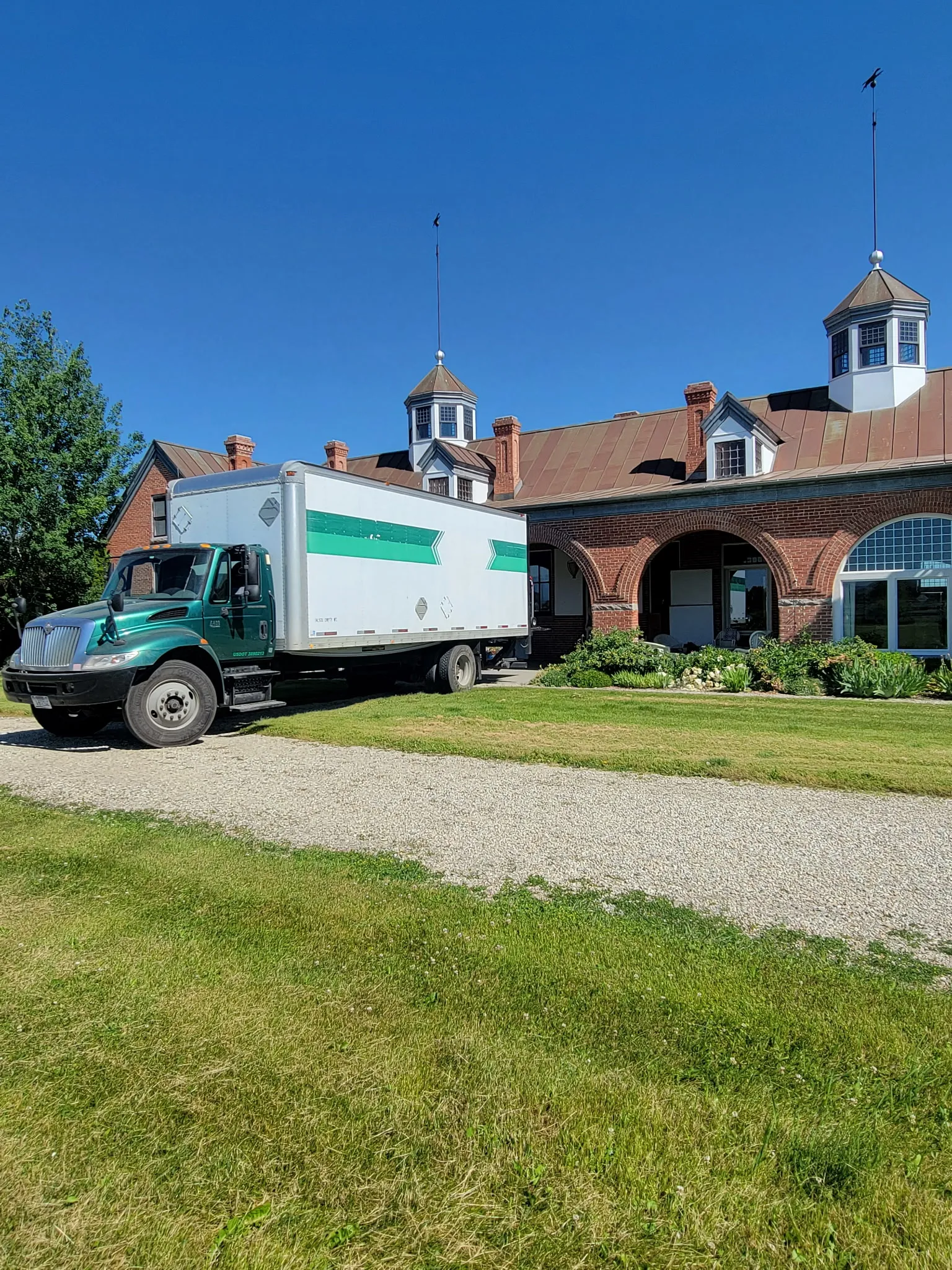 Moving On Up box truck parked at a large Missoula-area home